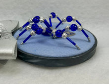 Load image into Gallery viewer, Vintage Metal Lion Shield Cufflink on Blue 4 Inch Hoop Spider
